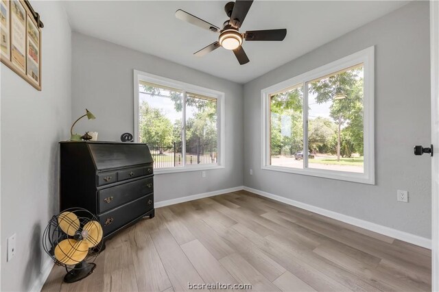 living area with ceiling fan and light hardwood / wood-style flooring