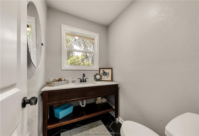 bathroom with vanity and toilet