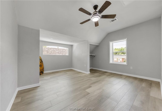 bonus room with ceiling fan, vaulted ceiling, and light wood-type flooring