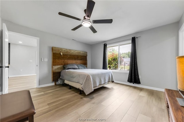 bedroom with ceiling fan and light wood-type flooring