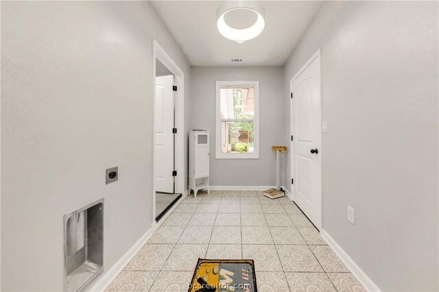 laundry area featuring hookup for an electric dryer and light tile patterned floors