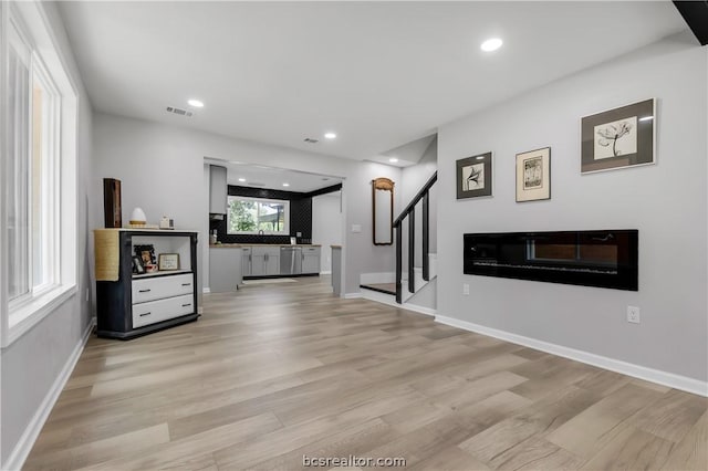 unfurnished living room with light wood-type flooring