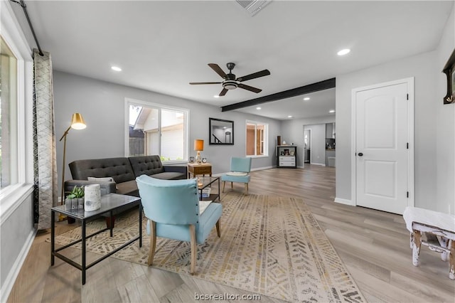 living room with ceiling fan and light hardwood / wood-style flooring