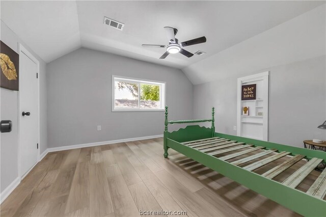 unfurnished bedroom with ceiling fan, light hardwood / wood-style flooring, and vaulted ceiling