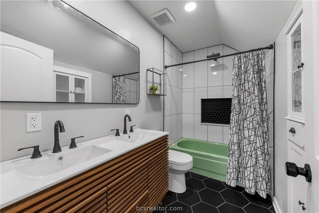 full bathroom with tile patterned floors, vanity, toilet, and shower / tub combo