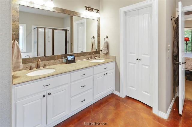 bathroom featuring vanity and an enclosed shower