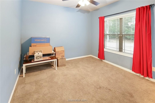 living area featuring carpet and ceiling fan