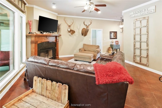 living room featuring crown molding, ceiling fan, plenty of natural light, and a premium fireplace