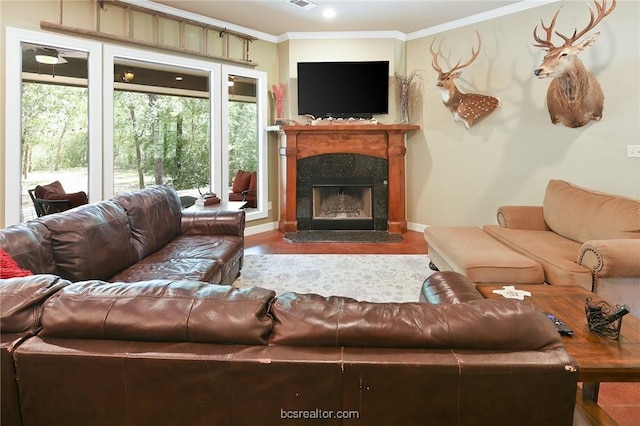 living room featuring ornamental molding and a premium fireplace