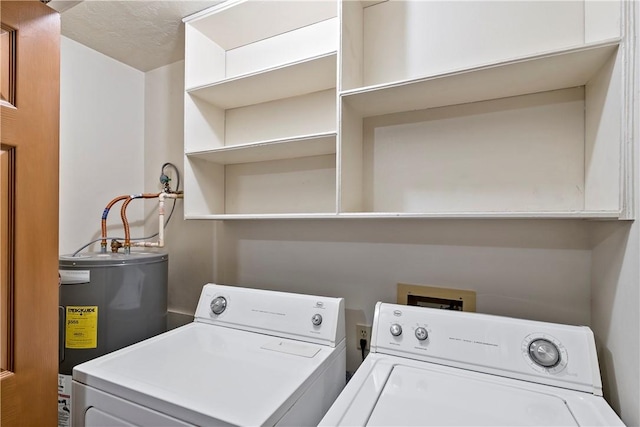 laundry room with electric water heater, a textured ceiling, and independent washer and dryer