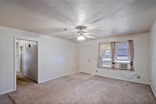 carpeted empty room featuring a textured ceiling and ceiling fan