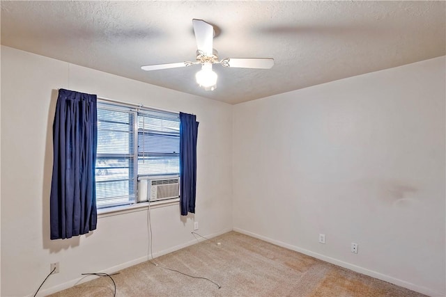 carpeted empty room featuring a textured ceiling, ceiling fan, and cooling unit