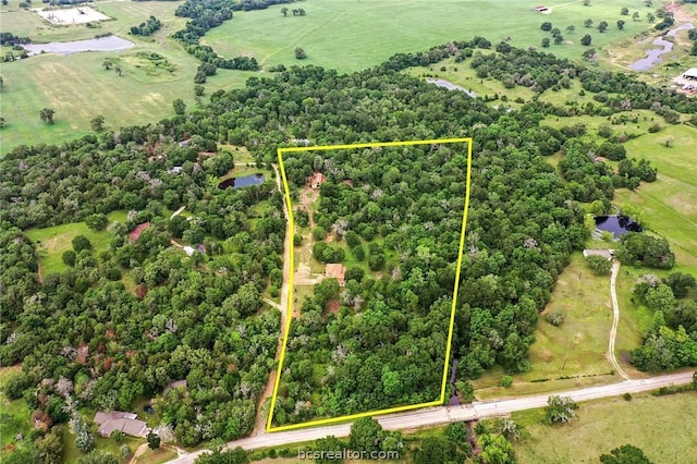 birds eye view of property with a rural view