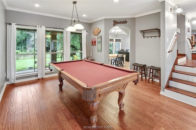 recreation room featuring ornamental molding, light wood-type flooring, a healthy amount of sunlight, and pool table