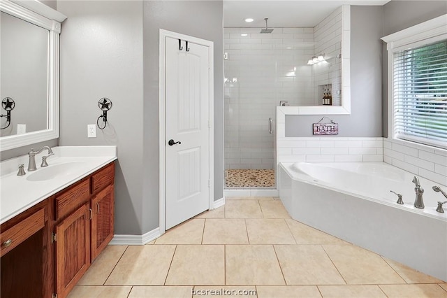 bathroom featuring tile patterned flooring, vanity, and separate shower and tub