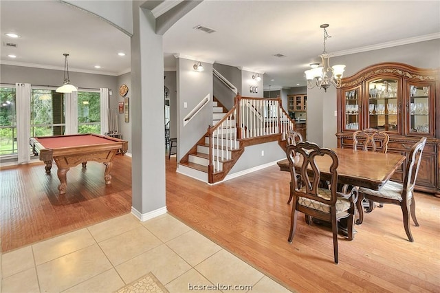 dining room featuring light hardwood / wood-style floors, ornamental molding, billiards, and an inviting chandelier