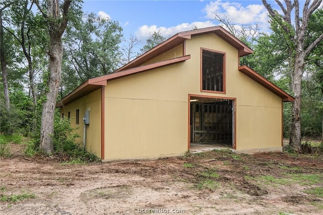 view of side of home with an outbuilding