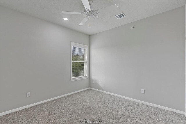 spare room with carpet flooring and ceiling fan