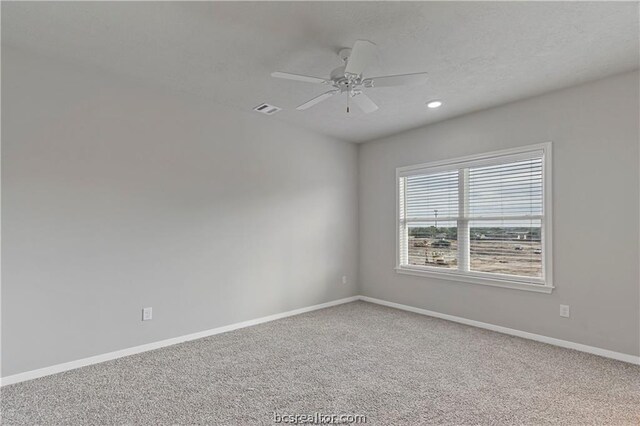 unfurnished room with carpet and ceiling fan