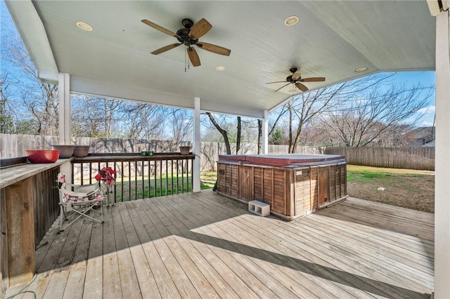 wooden deck featuring a hot tub and ceiling fan