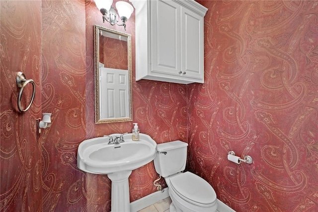 bathroom featuring toilet and tile patterned flooring