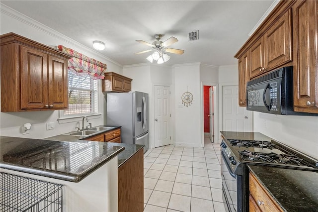 kitchen with sink, light tile patterned floors, crown molding, gas stove, and stainless steel fridge with ice dispenser