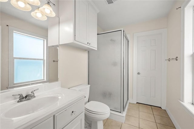 bathroom featuring walk in shower, vanity, toilet, and tile patterned flooring