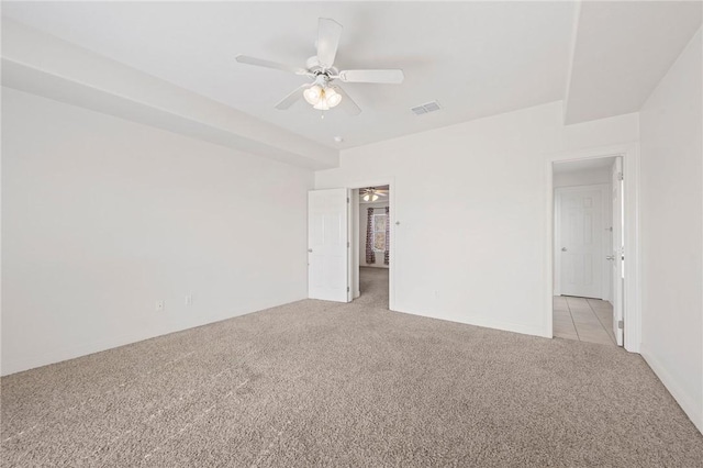 carpeted spare room with ceiling fan