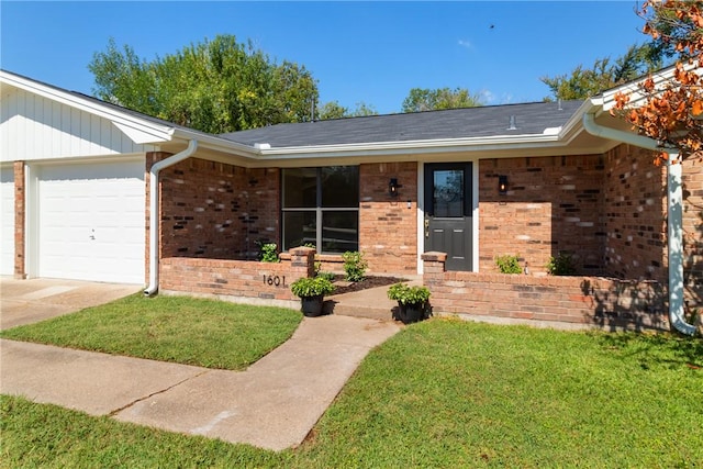 single story home with a front yard and a garage