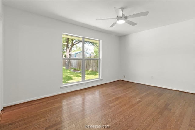 spare room with ceiling fan and wood-type flooring