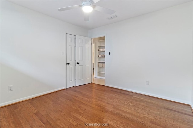 empty room featuring hardwood / wood-style floors and ceiling fan