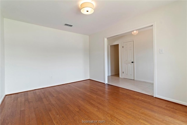 spare room featuring hardwood / wood-style floors