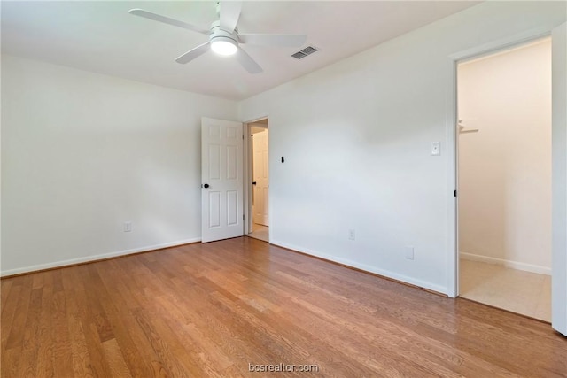 spare room featuring ceiling fan and light hardwood / wood-style floors