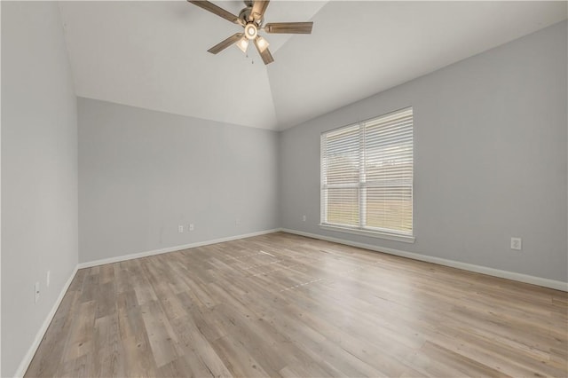 empty room featuring ceiling fan, lofted ceiling, and light hardwood / wood-style flooring