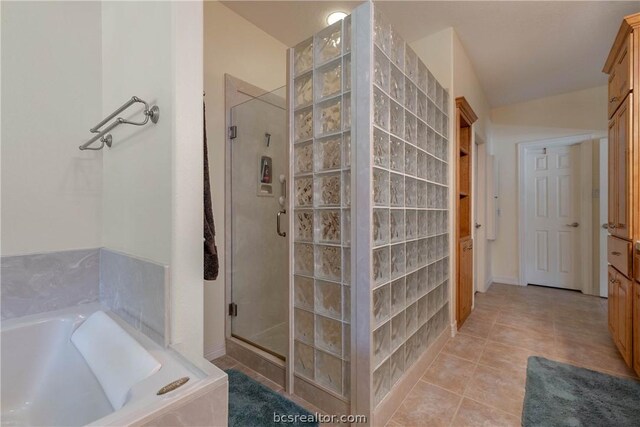 bathroom with separate shower and tub and tile patterned flooring