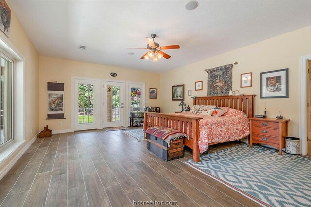 bedroom with wood-type flooring, access to outside, and ceiling fan