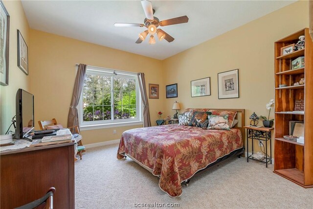 bedroom featuring light colored carpet and ceiling fan