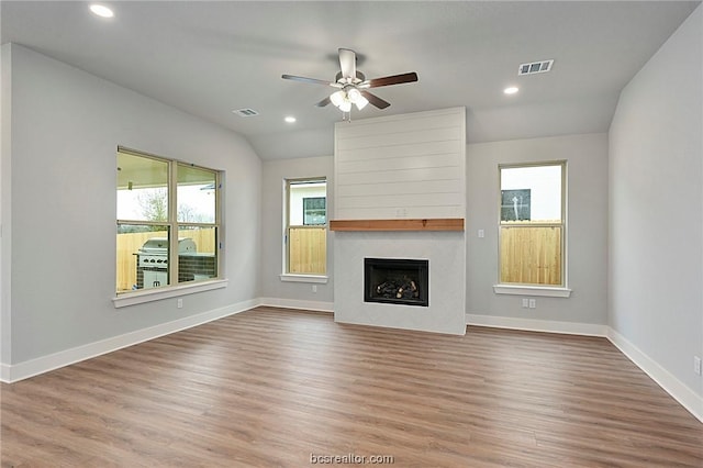 unfurnished living room with ceiling fan, vaulted ceiling, and hardwood / wood-style flooring