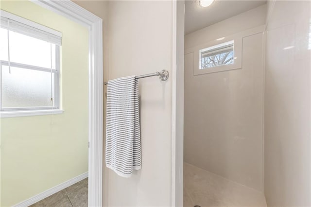 bathroom with tile patterned flooring and a wealth of natural light