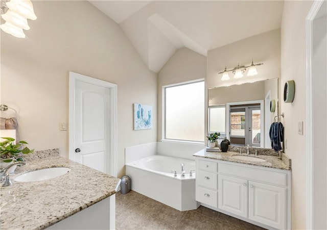 bathroom with lofted ceiling, tile patterned flooring, vanity, a bath, and french doors