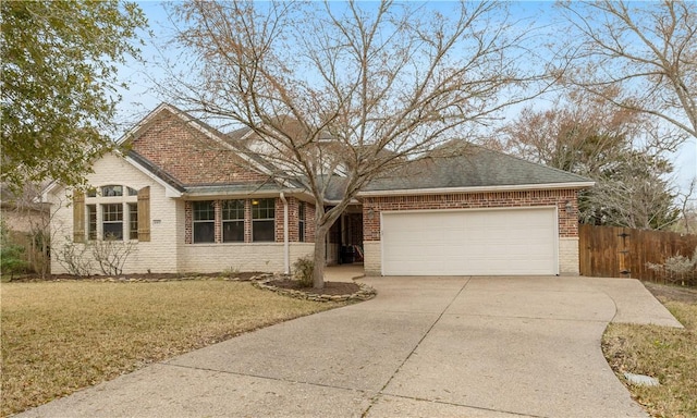 ranch-style home with a garage and a front lawn