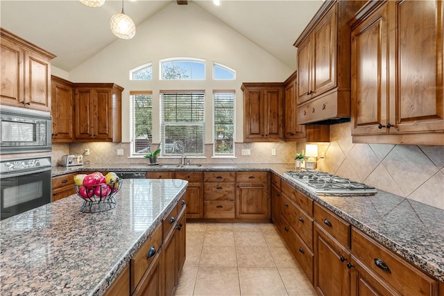 kitchen with built in microwave, stainless steel gas stovetop, sink, hanging light fixtures, and wall oven