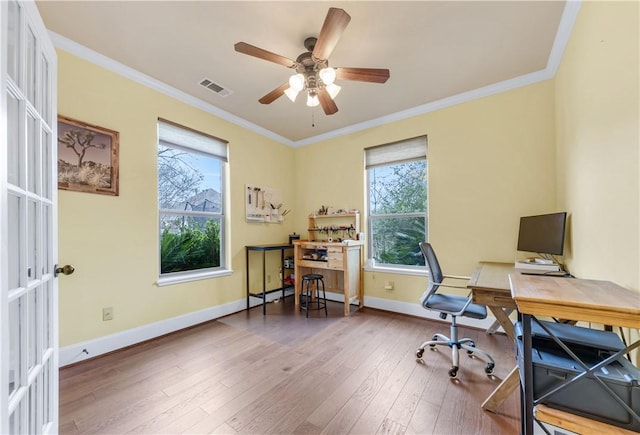 office space with hardwood / wood-style floors, crown molding, and ceiling fan