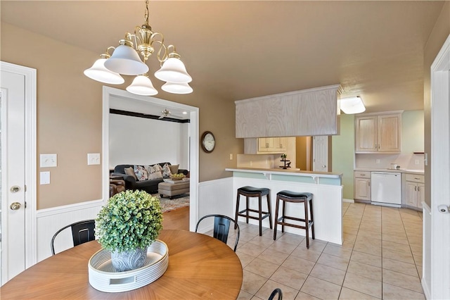 tiled dining area with an inviting chandelier