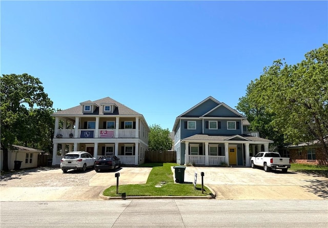 view of front of home featuring a porch, a front lawn, driveway, and a balcony
