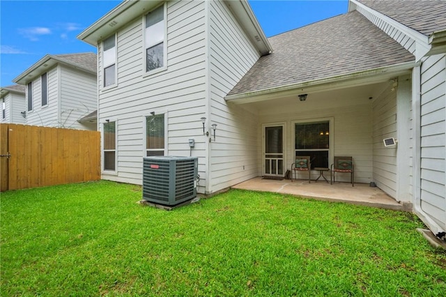 1610 Ethic Ln, College Station, TX 77845 - back of house featuring central air condition unit, roof with shingles, and a patio