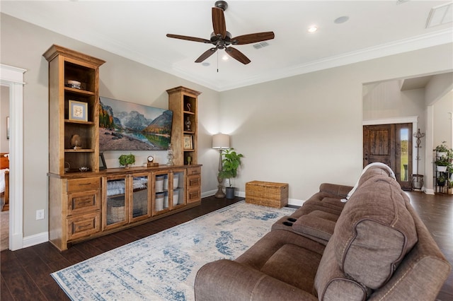 living room featuring dark wood-style floors, crown molding, and baseboards