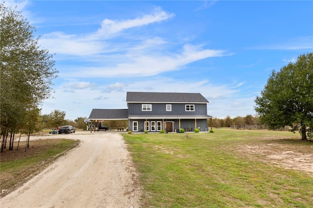 view of front of home featuring dirt driveway, a porch, and a front yard