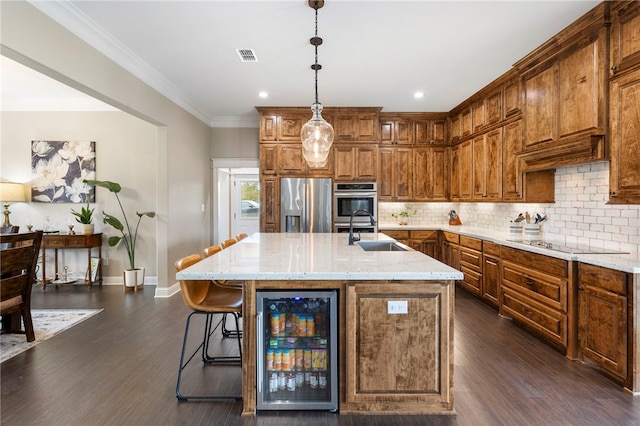 kitchen featuring beverage cooler, tasteful backsplash, visible vents, appliances with stainless steel finishes, and a sink