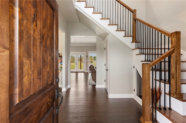 entryway with french doors, dark wood-style flooring, and stairway